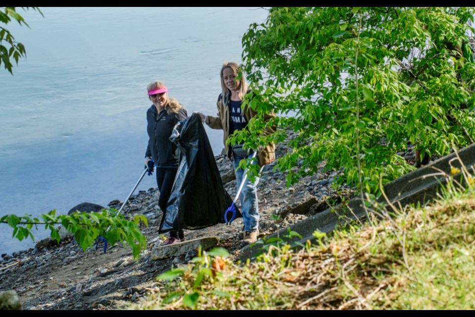 Cynthia James (left) and Heather Dumaresq were among the dozen or so volunteers to cleanup the beach from Riverside Park to Overlander Bridge on Wednesday morning. The group organized and met online in a Facebook group called, Save our Shores.