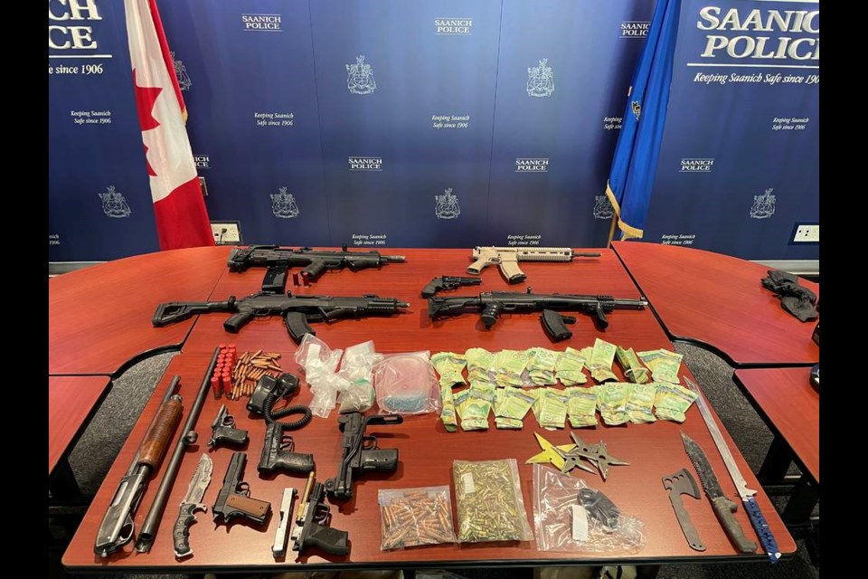 Saanich police found high-powered weapons and ammunition just inside an entrance to a Glasgow Avenue home that police said had been fortified from the inside. SAANICH POLICE