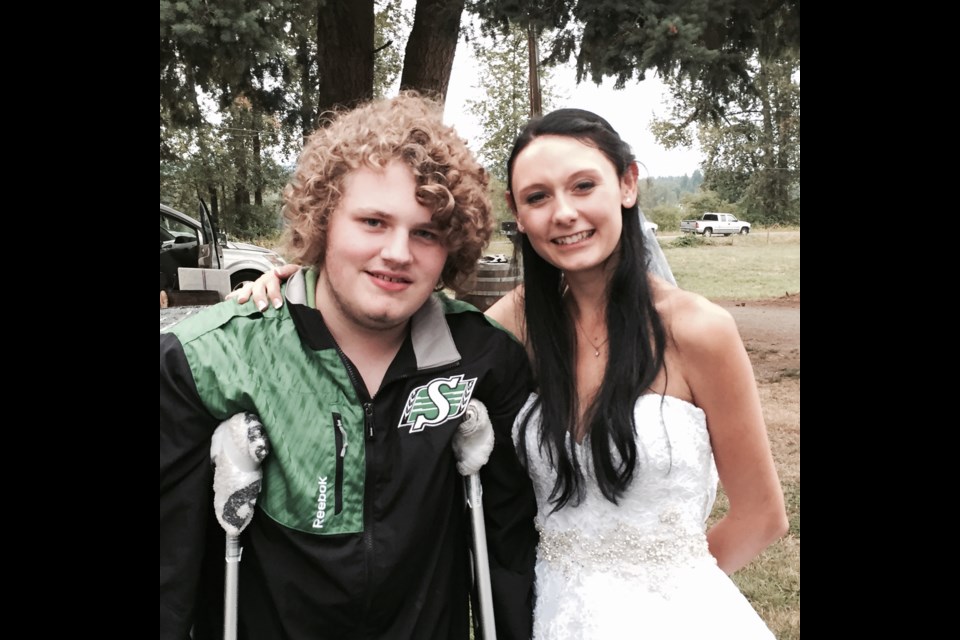 Ty Robinson with cousin Kirsten in 2015, donning a Saskatchewan Roughriders' jacket. Robinson was hired on June 29 as assistant equipment manager for the Riders, his favourite CFL team.