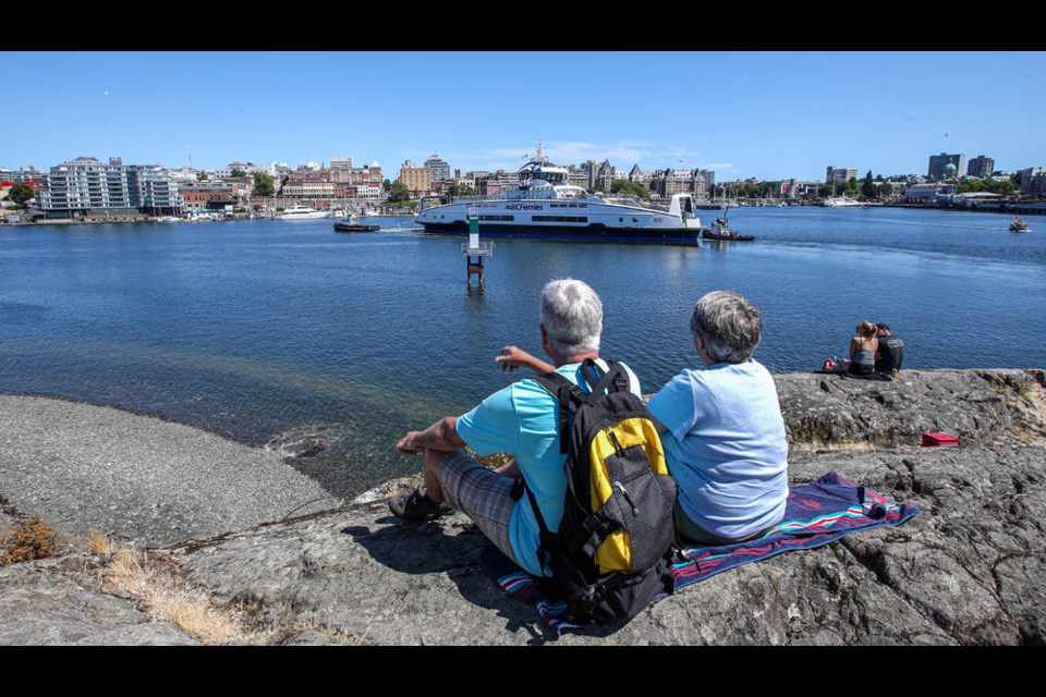 People out to watch the delivery of B.C. Ferries' third Island-class hybrid ferry, temporarily known as Island 3, to Point Hope Shipyard in Victoria on Thursday, July 22, 2021. ADRIAN LAM, TIMES COLONIST