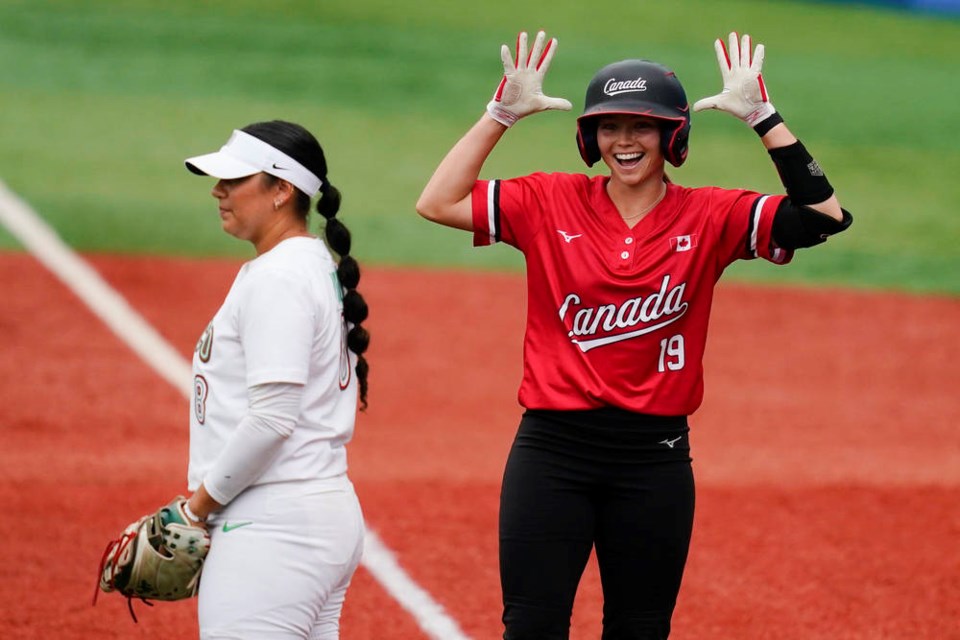 Standing along side Mexico infielder Victoria Vidales, left, Canadas Emma Entzminger, right, reacts after hitting a two run single during a softball game against Mexico at the 2020 Summer Olympics, Tuesday, July 27, 2021, in Yokohama, Japan (AP Photo/Matt Slocum)