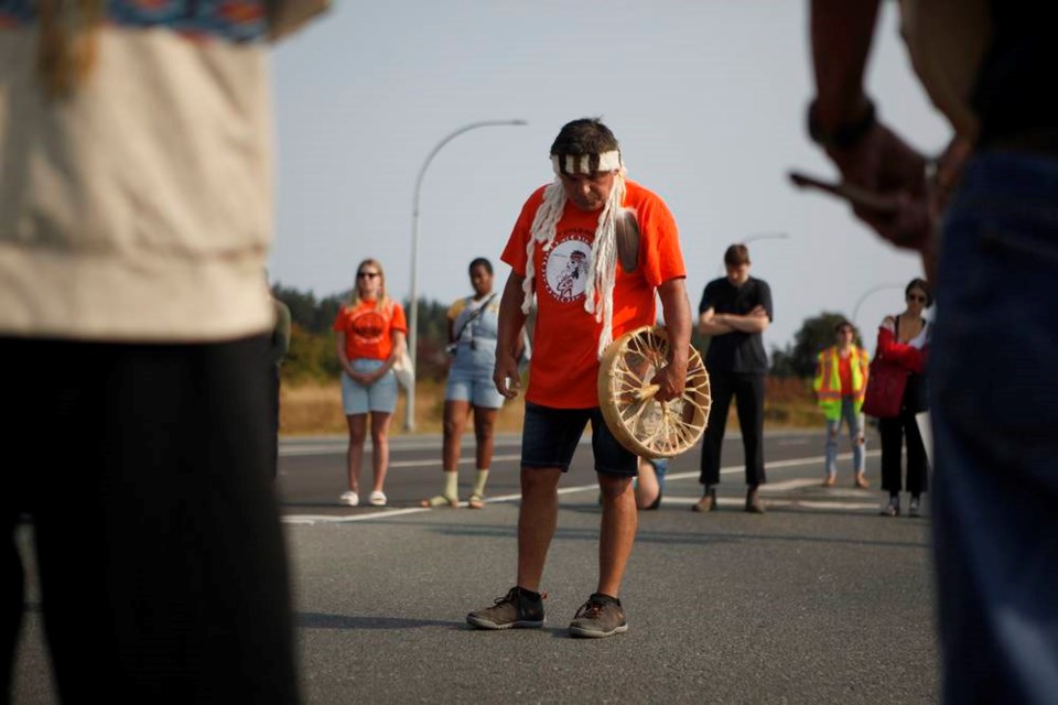 People including residential school survivors and children of survivors and supporters marched from the Tsawout First Nation band office to close down the Patricia Bay Highway at Mount Newton Cross Rd. in both directions for an hour this morning to take part in a drum circle in honour of the children who never made it home from residential schools. The event took place in Saanichton, B.C., on Monday, August 2, 2021. THE CANADIAN PRESS/Chad Hipolito