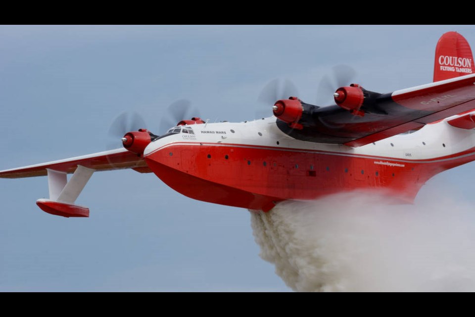 The Martin Mars Hawaii owned by the Coulson Group of Companies drops its massive load in this undated file photo. Chief executive Wayne Coulson believes the plane would have "a huge effect" on fires like the one burning near Ladysmith. COULSON GROUP OF COMPANIES