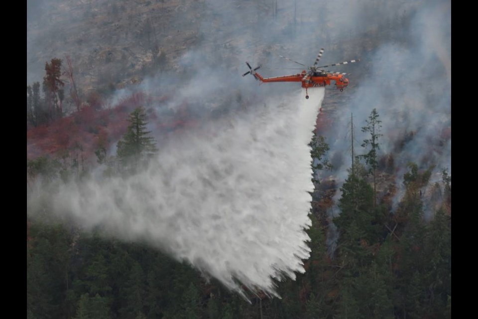 A helicopter unloads over the Mount Hayes fire near Ladysmith on Sunday, Aug. 22, 2021. B.C. WILDFIRE SERVICE