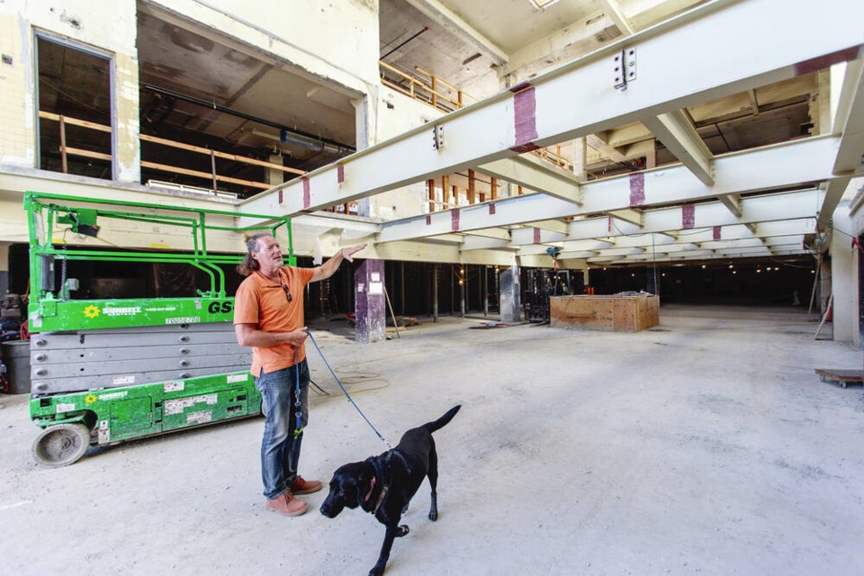 Merchant House Capital CEO David Fullbrook, with Labrador retriever Tank, on the main floor of the former Times Colonist building on Douglas Street, now called the Victoria Press Building. Fullbrook says tenants have so far committed to 63% of the 130,000 square feet of office space in the renovated building. DARREN STONE, TIMES COLONIST