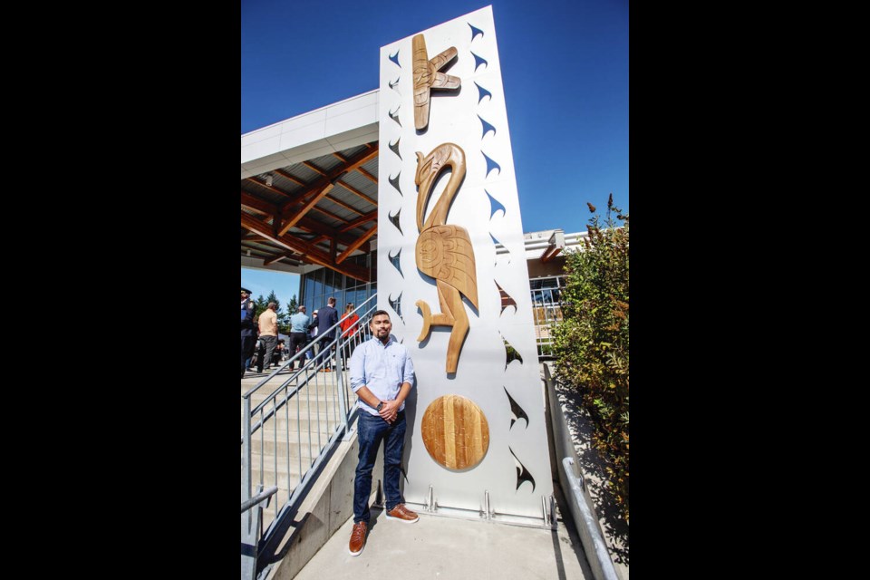 Tsawout artist and Camosun grad Douglas (Bear) Horne at the Cycle of Knowledge House Post in front of the Centre for Trades Education and Innovation on Thursday. DARREN STONE, TIMES COLONIST