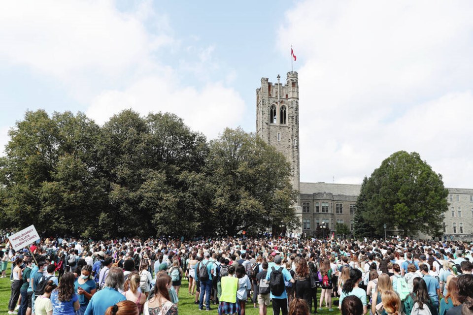 Western University students stand in the commons during a walkout in support of sexual assault survivors, in London, Ont., Friday, Sept. 17, 2021. THE CANADIAN PRESS/Nicole Osborne