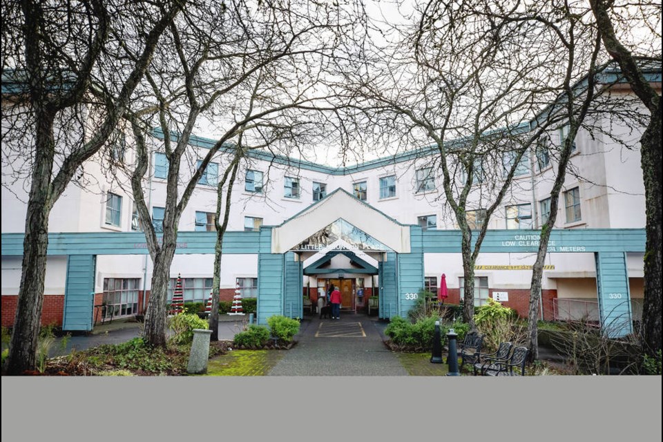 People wait to be screened before entering Little Mountain Place, a Vancouver long-term care home where dozens of residents died after a COVID-19 outbreak in November 2020. Facilities in the Island Health region fared much better than their counterparts on the mainland, with far fewer staff and resident cases per 1,000 beds than any other health authority in B.C. THE CANADIAN PRESS/Darryl Dyck