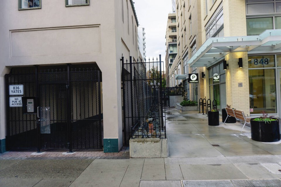 Locked walkways at 836 and 848 Yates St. (right), were intended to be one wide path but are currently separated by fencing. Nearby residents say maintaining the mid-block pedestrian route is important to livability in the downtown area. TIMES COLONIST