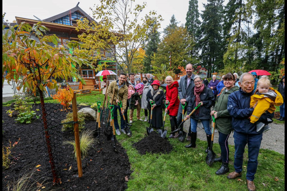 Members of the Takata family — Dillion and Lisa, left, with baby Kana, Brendan and Kayla, with Anya, and David, with Enzo, far right — are joined by Esquimalt Coun. Lynda Hundleby, Mayor Barb Desjardins and councillors Ken Armour, Meagan Brame and Jane Vermeulen at the ceremonial planting of a cherry forest and the Takata Garden at Esquimalt Gorge Park on Friday, Oct. 15, 2021. ADRIAN LAM, TIMES COLONIST