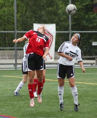 A step on the opposition: Mountain United FC, in red, defeated Coquitlam Metro-Ford 1-0 in the under-18 girls' Provincial Premier Cup semifinal at Burnaby Lake Sports Complex-West on Saturday.
