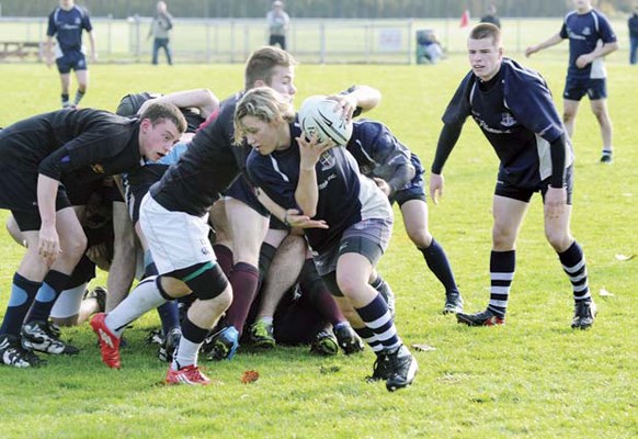 Going forward: Burnaby Lake forward Sarah Lepine, with ball, makes a break in under-19 club rugby match against United at Burnaby Lake Sports Complex-East last Saturday. Trent Shelley, seen at left, scored both tries for Burnaby in a 17-15 loss to United. Kip Dickson, with two five-pointers, and Blake Chernoff tallied for the United club.