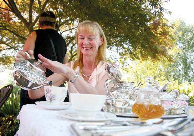 Mona Franks pouring freshly brewed tea at the Art In Bloom and English Tea Party at the Port Royal Community Garden in Queensborough last weekend.