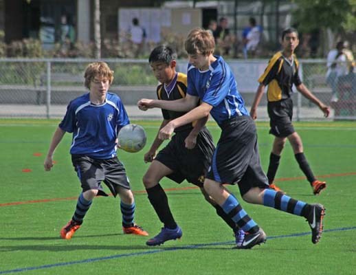 First of the season: Royal City United, in blue, took on Wesburn United in an under-15 gold youth soccer match at Burnaby Lake Sports Complex-West on Saturday.
