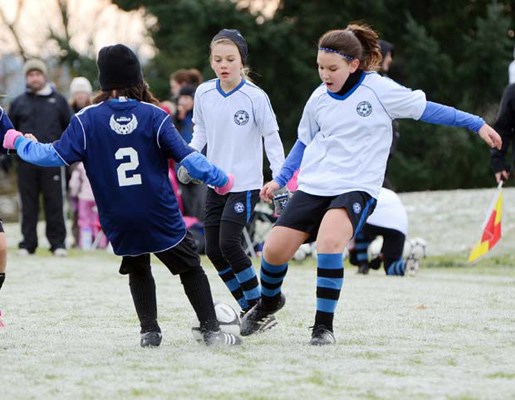 Toe-to-toe: The Royal City Funky Monkeys, in white, played Coquitlam Metro-Ford Angels to a 1-1 draw in under-10 Tri-Cities league soccer last weekend.