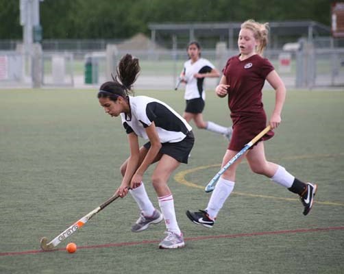 Outdoor hockey: The Burnaby Explosion, in white, took on the West Vancouver Monkeys in an under-15 girls' field hockey league match at Burnaby Lake Sports Complex-West last Saturday.