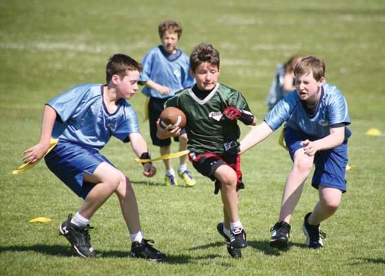 Wave the flag: The Burnaby Lions, in green, and the New Westminster Hyacks, in orange, took part in a Mainland football league spring flag football tournament at Mercer Stadium in New Westminster last Saturday.
