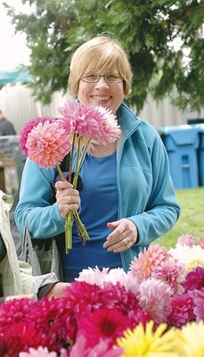 Fresh flowers: Above, Betty Allen picks herself a bouquet of dahlias during the Sunday event. The 2011 edition of the fair is happening this Sunday, Sept. 18.