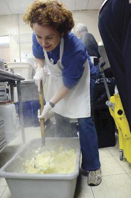 Plenty of potatoes: Kandi Anderson mashes potatoes that were served at the Union Gospel's Mission's annual Thanksgiving Day dinner in New Westminster on Monday.