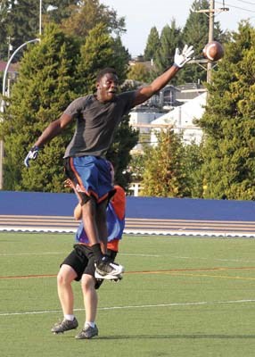 Former New Westminster Hyack running back Blain Cawkell goes up high for a ball during the alumni touch football game on Sept. 14 at Mercer Stadium. Cawkell was one of more than 50 former players to come back for the 10th anniversary celebrations.