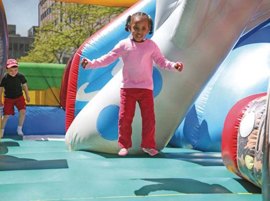 Fun in the sun: A bouncy castle and bouncy slide were fan favourites among the little ones attending Uptown Live! Sarah Osman was among those who enjoyed a bounce.