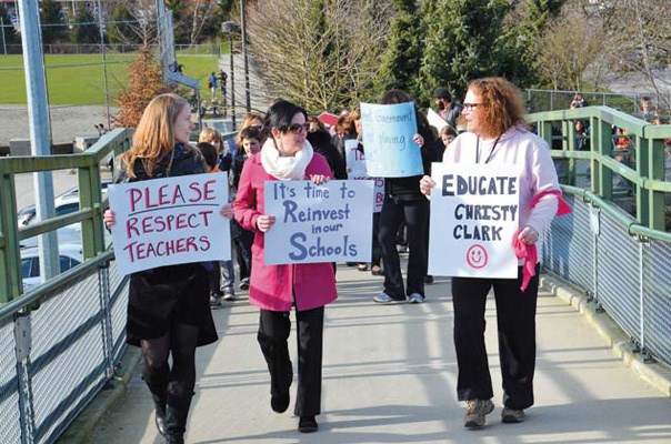 Taking action: Teachers from Glenbrook Middle School, F.W. Howay Elementary, Hume Park Elementary and members of CUPE local 409 took to the McBride overpass to protest the government's plan to impose a law to end a contentious contract dispute.