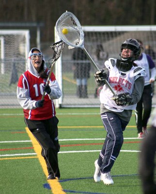 Having fun: New Westminster, in red, and Burnaby bring out the fun side of field lacrosse in an under-19 girls' matchup at Burnaby Lake Sports Complex-West last Saturday.