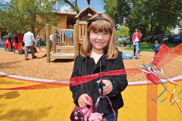 In Megan's memory: Riley Gunderson cuts the ribbon to mark the grand opening of Megan's Place tiny tots playground in Ryall Park. A picnic and children's festival was held Sunday to celebrate the reopening of the new and improved playground and spray park in Queensborough. The playground was named in honour of three-year-old Megan Gunderson, who was killed after being hit by a vehicle in front of her Queensborough home in 1996. Riley is Megan's cousin.