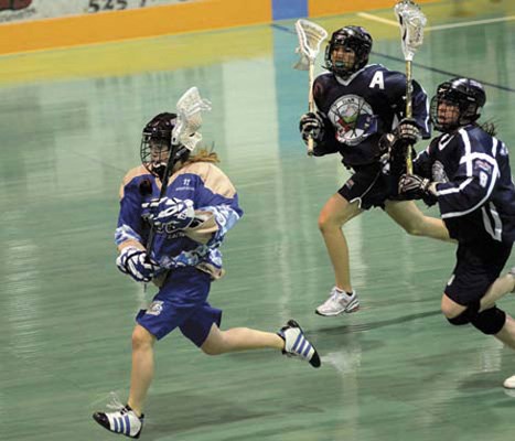A merry chase: New Westminster's Emily Manville, in blue, breaks away from a pair of Alberta runners in a 9-2 win over the Prairie team at the Canadian bantam girls' lacrosse championships at Queen's Park Arena July 24. The bantam and midget girls' finals will be held on Thursday, beginning at 2:15 p.m.