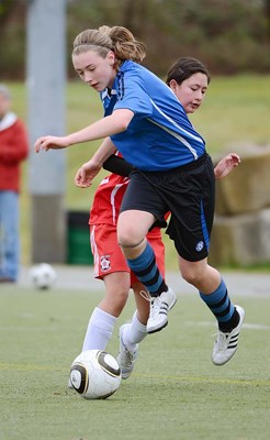 Jump to it: Royal City Soccer's Stephanie von Riedemann, in blue, makes a play against the Burnaby Girls club in a 1-0 loss in an under-15 silver level soccer game.