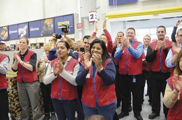 Hooray: Some of the 180 employees hired by Lowe's cheer as the store is officially opened, not with a ribbon cutting but with a board cutting.