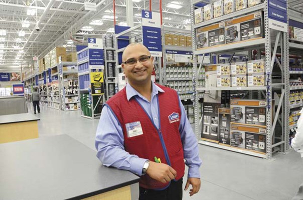 Amit Dass , assistant store manager at Lowe's in Queensborough, is all smiles on one of his first days on the job. The store opened its doors on Monday but grand opening festivities continue through the weekend.