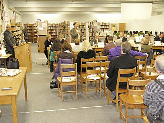 School board candidate and 32-year school trustee veteran Michael Ewen, standing on left, answers a question during Thursday night's school trustee all-candidates meeting in the NWSS library.