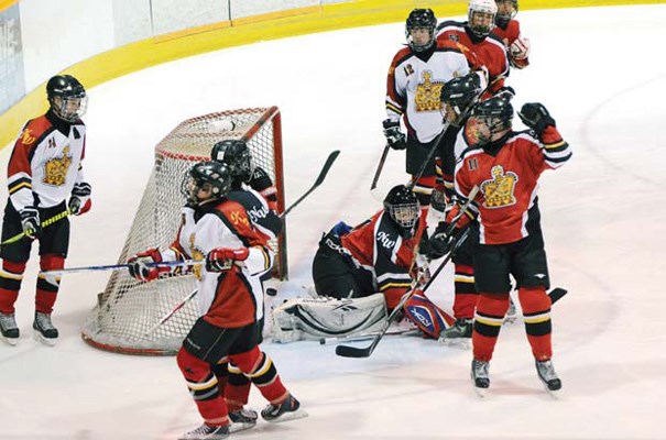 Goal: New Westminster C1's Paul Radnidge, hand raised, watches shot slip past goalie Garrett Cahill and into the net in 7-2 loss in all-New West bronze final.