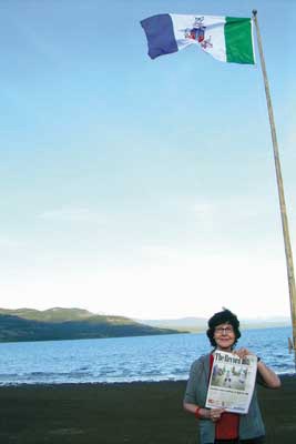 Northern adventure: Annette Martin of New Westminster took her Record along when she went to the Yukon to visit her baby granddaughter Phoenix Rose Cairns and family and friends. Here, she's at Marsh Lake, where it stays light for about 18 to 20 hours a day at this time of year.