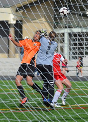 Going for goal: New Westminster's Navneet Mahal (orange) takes a shot on net during a senior girls' soccer game against Burnaby Central Secondary April 16 in New Westminster. Mahal was one of two goal scorers for the Royal City team. Burnaby managed to come back from a 2-0 deficit to tie New West 2-0.