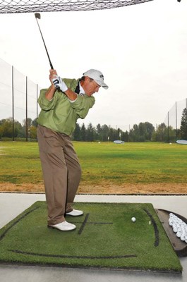 Burnaby Mountain teaching professional Brad Ewart shows off his butter-smooth swing for his students.