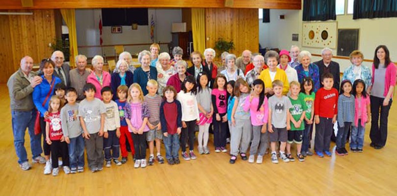 Let's read: Sapperton seniors and students from Stella Horbal's Grade 1-2 class at Richard McBride Elementary School pose for a photo. The students spent a few hours at the Sapperton Pensioners Hall recently to read to the seniors there.