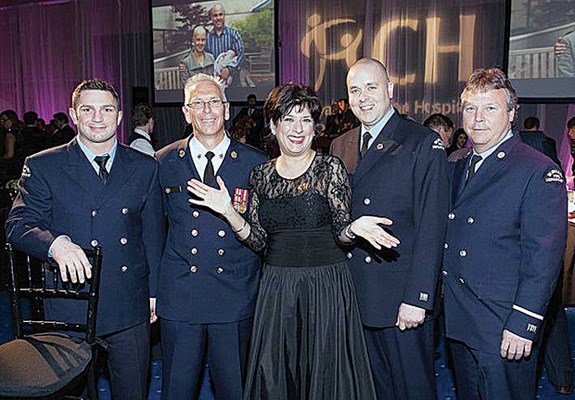 Time to shine: RCH Foundation board chair Belle Puri poses with members of the Burnaby Firefighters Charitable Society, the title sponsor of this year's SHINE Gala.