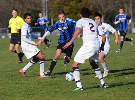 Rovers over: Rovers United Jas Kooner, left, Colin Soo, right, and Canadian under-23 international Derrick Bassi, No. 2, close in on a Coquitlam Metro-Ford attacker in a 2-1 victory at Confederation oval on Sunday. Kyree Melo on a free kick and Derek Spanjers, with the game-winner, tallied for the Rovers, who moved into fourth place in the u-21 division of the Vancouver Metro Soccer League.