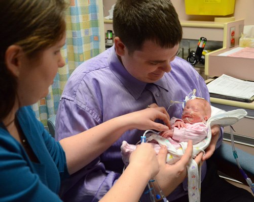 Tiny bundle: Jason and Natasha Pinch with daughter Rebecca, who was born at 28 weeks. She's now four weeks old and weighs about three pounds.