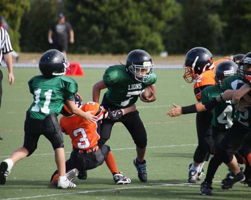 Orange crush: The Royal City Hyacks atom orange team, in orange, defeated the Burnaby Lions 19-0 at Mercer Stadium on Sunday.
