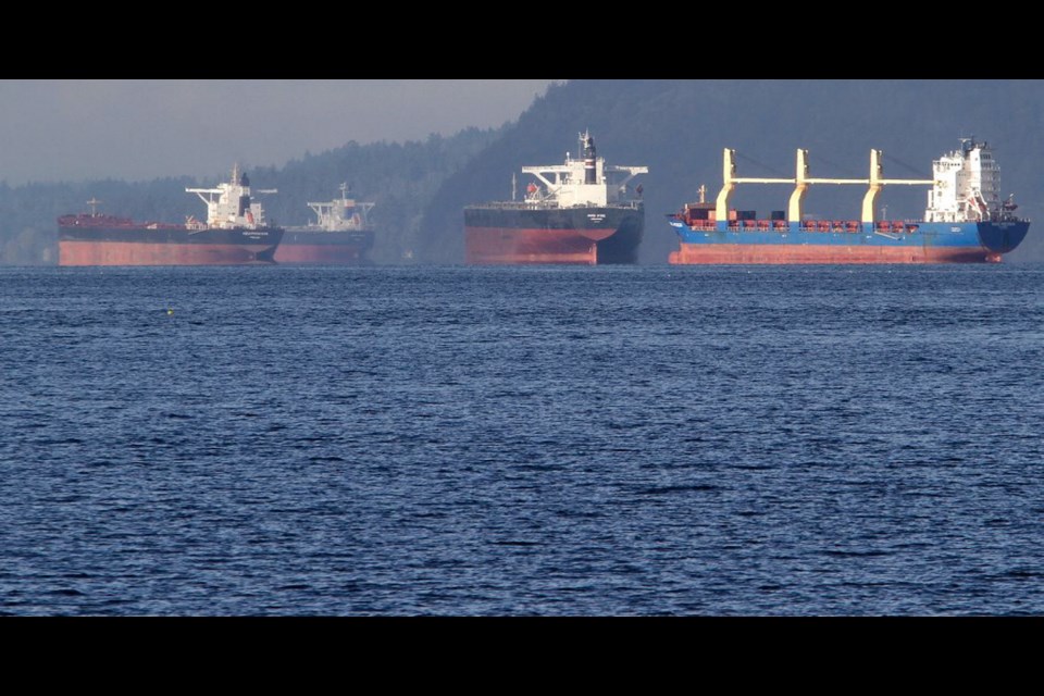 Freighters wait in Satellite Channel before heading to Vancouver to take on their cargo.