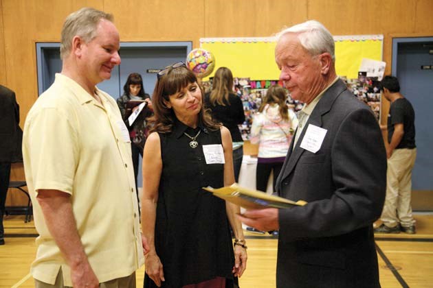 Herbert Spencer principal Tracy Fulton, centre, and her husband Jack Fulton, left, are former students. The couple talks with fellow alumni James Peart, who went to the school from 1936 to 1942.