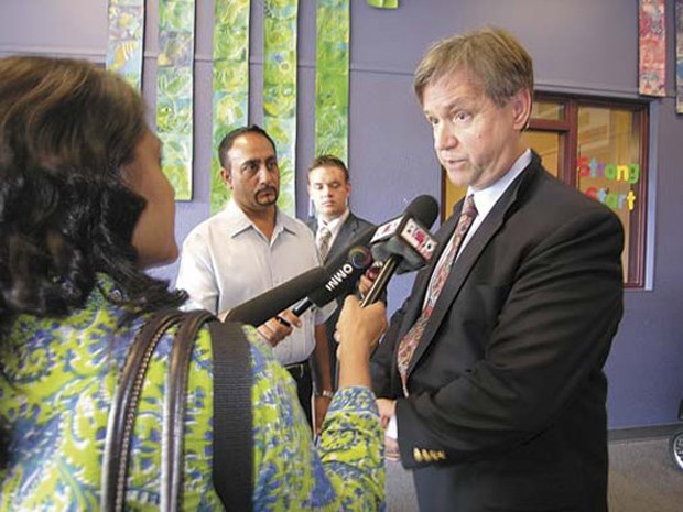 Education Minister George Abbott questioned by the press at Queen Elizabeth Community School in Queensborough on Monday. The minister came to see the new modular buildings brought in to make room for full-day kindergarten.