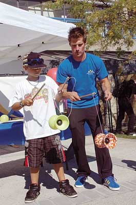 Tricks: Eight-year-old Halen Rasmussen gets some tips from Travis Johnson with the Vancouver Circus School at last year's Artists on the River Festival. The festival returns this year on Friday and Saturday, Sept. 23 and 24.