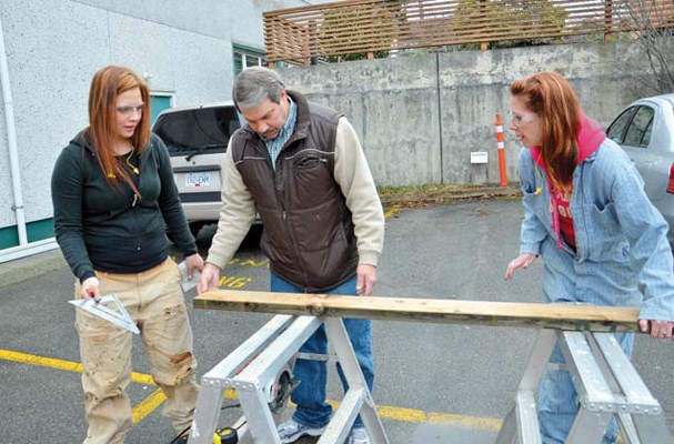 A helping hand: Red Seal carpenter Don Laslo helps sisters Diamond Delavalle and Melissa Lance, who were part of a 18-woman team building a garden shed for the New Westminster Lions.