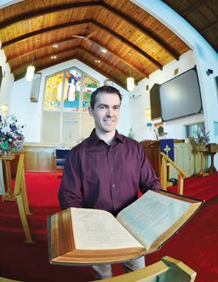 Historical artifacts: Rev. Tim Bruneau is preparing for celebrations to mark the 150th anniversary of the Presbyterian Church in New Westminster. Events include an open house, where artifacts, such as this Bible, will be on display.