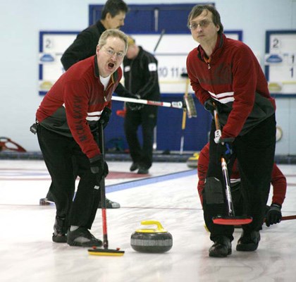 Hard at it: Royal City Curling Club sweeper Berry Breton, left, and second Richard Bower guide a rock down the ice for skip Mel Steffin's entry at the senior men's interregional playdown at the Royal City club last Saturday. The Steffin rink finished with a 6-3 record but still failed to qualify for the provincial championships.