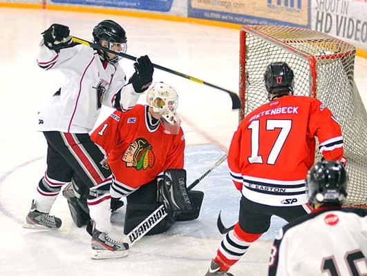 In the net: Northwest Giants Anthony Conti, left, scores one of this two goals in a 3-1 major midget hockey win over the Valley West Hawks at the Burnaby Winter Club on Sunday.